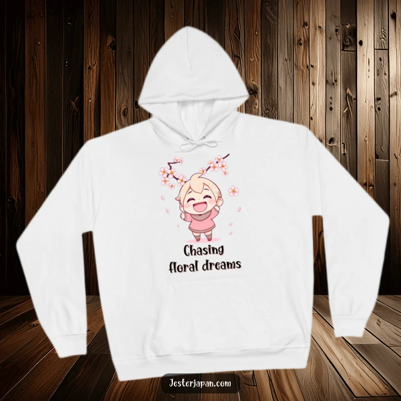 Funny hoodie depicting a character with a wide grin attempting to catch falling cherry blossoms, bringing cozy spring vibes.