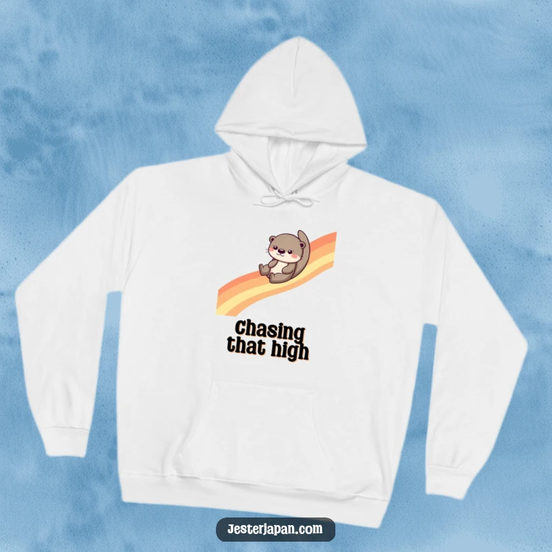 Funny otter sliding down a colorful rainbow, depicted on a cozy hoodie, offering warmth and a smile to the wearer.