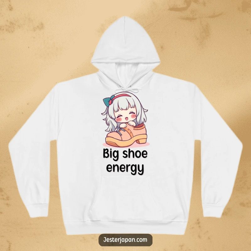 Funny hoodie featuring a character with rosy cheeks playfully trying on an oversized geta shoe, blending warmth and humor.