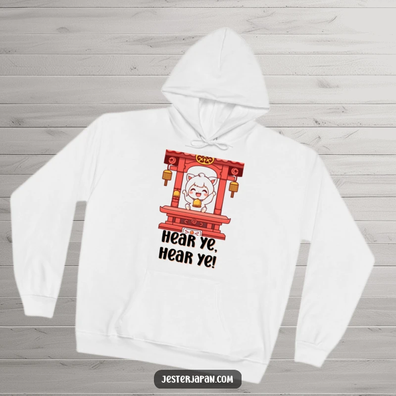 Funny hoodie with a character in a moment of pure joy, ringing a tiny temple bell, exuding warmth and cheerful energy.