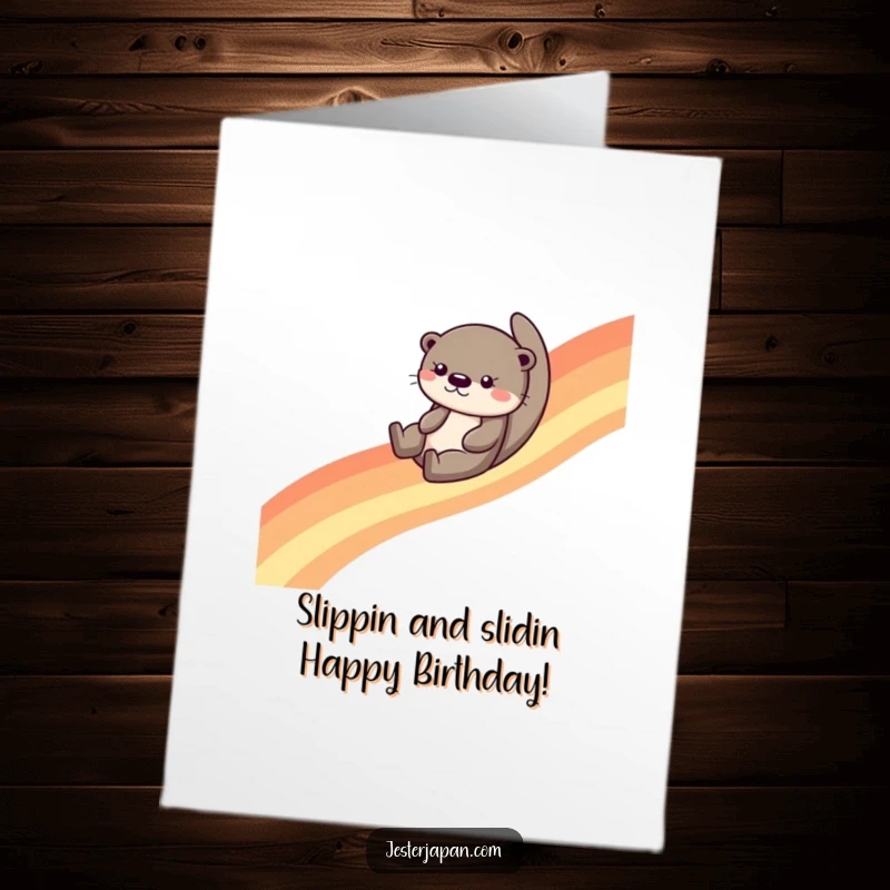 Funny Free Printable Birthday Card: Giggling otter slides down a vibrant rainbow, spreading cheer for a downloadable gift.