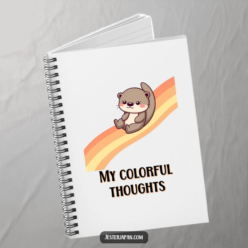 Funny otter sliding down a vibrant rainbow, featured on the cover of a spiral notebook, encouraging creative and joyful writing.
